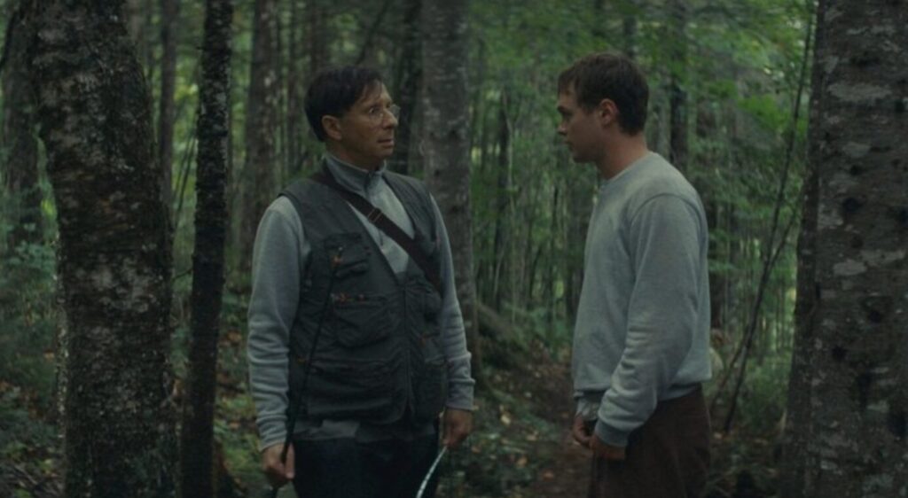 Two men speaking in the woods